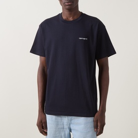 Model wearing Carhartt crew neck T-shirt in dark navy with small white chest script logo, styled with light blue jeans.