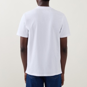 Model wearing Carhartt Crew Neck T in white, rear view, short sleeves, styled with blue jeans.