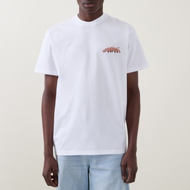 Model wearing Carhartt white crew neck T-shirt with small red graphic logo on chest, styled with light blue jeans.