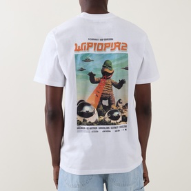 Model wearing Carhartt white crew neck T-shirt, back view showing large sci-fi monster graphic print.