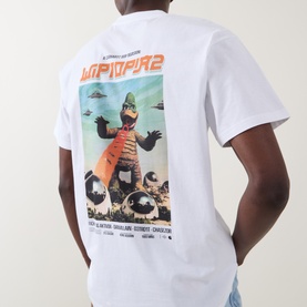 Model wearing Carhartt white crew neck T-shirt, back view showing large graphic movie poster print featuring monster character.