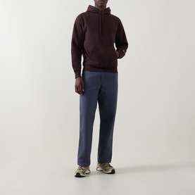 Model wearing Carhartt palisander hoodie with blue trousers and multicoloured trainers