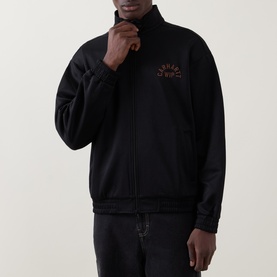 Model wearing Carhartt black zip-through sweatshirt with mock neck, tonal chest logo graphic, and black trousers.
