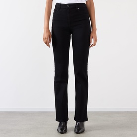 Model wearing FRAME DENIM Reboot Bootcut Jeans in black, high-rise with bootcut leg, styled with black ankle boots