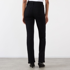 Model wearing FRAME DENIM Reboot Bootcut Jeans in black, high-rise with bootcut leg and tonal stitching, styled with black ankle boots.