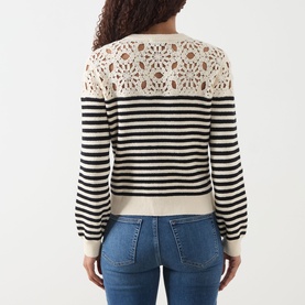 Model wearing FRAME DENIM The Coastal Striped Cardigan in Cream Multi, back view showing crochet shoulder detail and black stripe pattern, styled