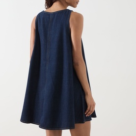 Model wearing FRAME DENIM Dress in Duomo, sleeveless A-line denim mini with centre seam detail, back view