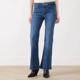 Model wearing FRAME DENIM Flare Jeans in Provence blue denim, styled with black ankle boots