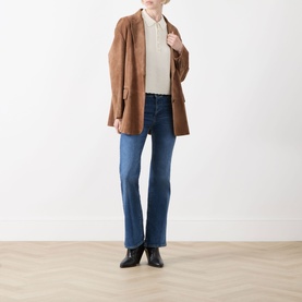 Model wearing FRAME DENIM Provence flare jeans in mid-blue wash, styled with a tan suede blazer, cream top and black ankle boots.