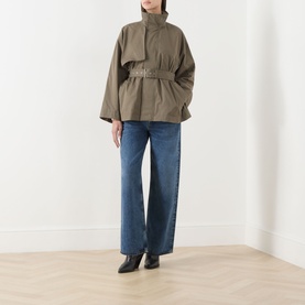 Model wearing FRAME DENIM Army cotton jacket with belted waist and high neck, styled with wide-leg blue jeans and black ankle boots
