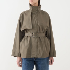 Model wearing FRAME DENIM Army cotton jacket with high funnel neck, oversized fit, and belted waist, styled with blue jeans.
