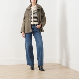 Model wearing FRAME DENIM Army cotton jacket, styled with stripe top, blue wide-leg jeans and black ankle boots.