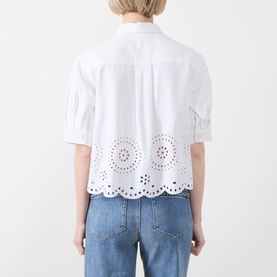 Model wearing FRAME DENIM white cotton-lyocell shirt, back view, broderie anglaise scalloped hem, short sleeves, styled with blue jeans