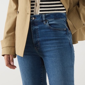 Model wearing FRAME DENIM Straight Jeans in Daylily Raw Fray, styled with a striped top and camel blazer.