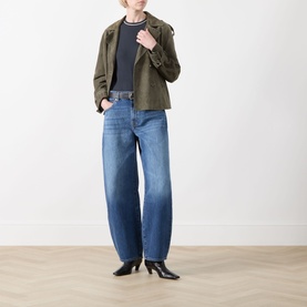 Model wearing FRAME DENIM Navy Multi cotton T-shirt, styled with olive cropped jacket, wide-leg blue jeans and black heeled boots.
