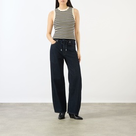 Model wearing FRAME DENIM Coastal Stripe Tank Top in Cream Multi with navy wide-leg drawstring trousers and black heeled mules.