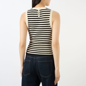 Model wearing FRAME DENIM Coastal Stripe Tank Top in Cream Multi with black horizontal stripes, sleeveless, styled with dark indigo jeans. Rear view.
