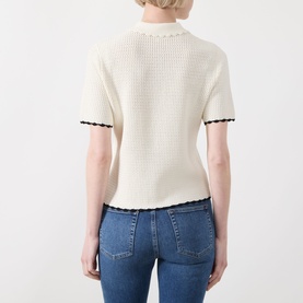 Model wearing FRAME DENIM Cream Multi knit top, back view, short sleeves with dark contrast scallop trim, styled with blue jeans.