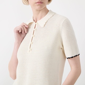 Model wearing FRAME DENIM Cream Multi crochet-knit polo top with short sleeves and contrast scallop trim detail.