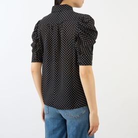 Model wearing FRAME DENIM Gillian Polka Dot Blouse in Black Multi silk, with standing collar and elbow-length puff sleeves, styled with blue jeans
