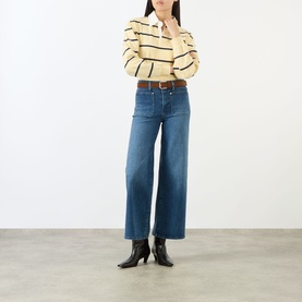 Model wearing FRAME DENIM Le Slim Palazzo High-Rise Wide Leg Jeans in Archive, styled with a striped polo and black ankle boots.