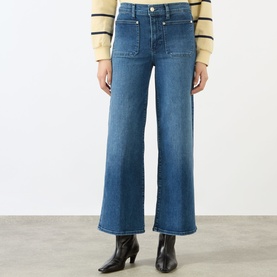Model wearing FRAME DENIM Le Slim Palazzo High-Rise Wide Leg Jeans in Archive blue with front patch pockets and tobacco stitching, styled with black