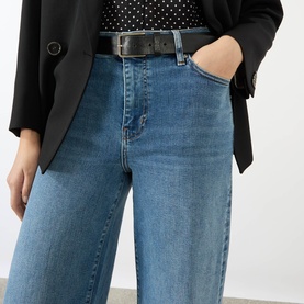 Model wearing FRAME DENIM Le Slim Palazzo High-Rise Wide Leg Jeans in Gossamer, styled with a black blazer and leather belt.