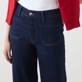 Model wearing FRAME DENIM Le Slim Palazzo Wide-Leg Jeans in Rinse, showing front patch pockets, tobacco stitching and high-rise waist