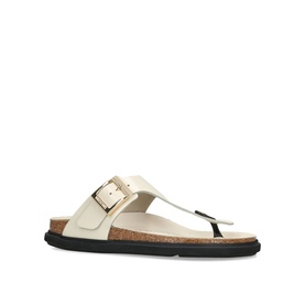 Birkenstock cream leather toe-post sandal with oversized gold buckle strap, cork footbed, and black sole