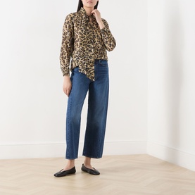 Model wearing Mother Half Pipe High-Rise Ankle Jeans in wide-leg dark blue denim, styled with leopard print blouse and black flat mules.