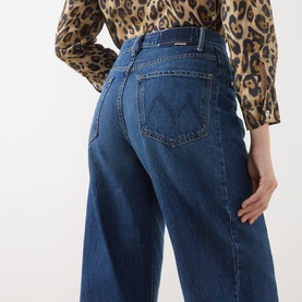 Model wearing Mother Half Pipe High-Rise Ankle Jeans in Did You Bring Me Anything, wide-leg, M-stitched back pockets, styled with leopard print top.