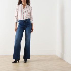 Model wearing Mother Jeans in Homecoming High dark blue wide-leg denim, styled with a striped shirt and black heels.