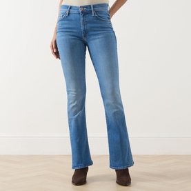 Model wearing Mother jeans in Piece By Piece blue denim, flared bootcut silhouette, styled with brown ankle boots.