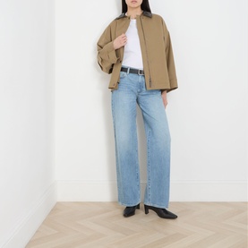 Model wearing Paige Dana Low-Rise Straight Leg Jeans in Sepulveda, styled with a tan overshirt, white tee, and black heeled mules.