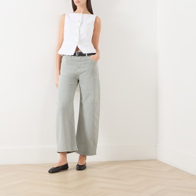 Model wearing Paige Arellia Ankle Wide-Leg Jeans in Vintage Seaglass, styled with a white sleeveless top and black belt.