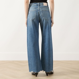 Model wearing Paige Wide Leg Jeans in Terazzo Deconstructed, rear view, high-rise fit, frayed hem, 100% cotton denim