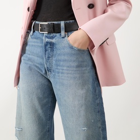 Model wearing Paige Wide Leg Jeans in Terazzo Deconstructed, styled with a pink blazer and black belt.