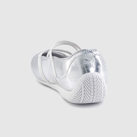 Silver metallic flat shoe with cross-strap upper and patterned rubber sole, shown from rear angle