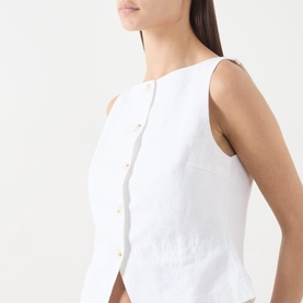Model wearing Samsoe & Samsoe white linen sleeveless blouse with gold-tone button fastening, close-up side view.
