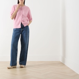 Model wearing Samsoe & Samsoe Saanoura Rib Knit Cardigan in Bleached Mauve, styled with wide-leg blue jeans and flat shoes