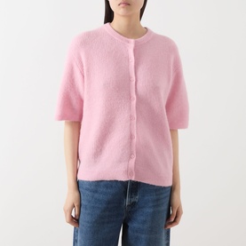 Model wearing Samsoe & Samsoe Saanoura Rib Knit Cardigan in Bleached Mauve, short sleeves, round neck, button front, styled with blue jeans.