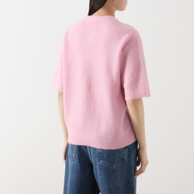 Model wearing Samsoe & Samsoe Saanoura Rib Knit Cardigan in Bleached Mauve, short sleeves, round neck, styled with blue jeans. Rear view.