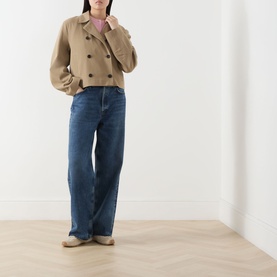 Model wearing Samsoe & Samsoe Sakit Double-Breasted Jacket in Lead Gray with flat collar, styled with blue wide-leg jeans and flat shoes.
