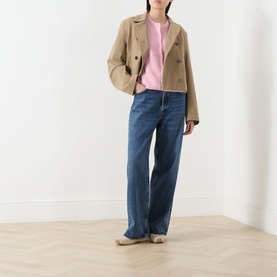 Model wearing Samsoe & Samsoe Sakit Double-Breasted Jacket in Lead Gray, styled with pink top and wide-leg blue jeans