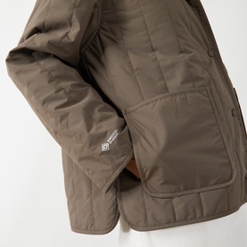 Samsoe & Samsoe Major Brown quilted polyamide jacket, close-up of chest pocket and small woven brand label detail.