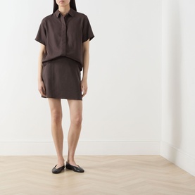 Model wearing Samsoe & Samsoe Mina Fluid Shirt in Mulch with matching mini skirt and black ballet flats.
