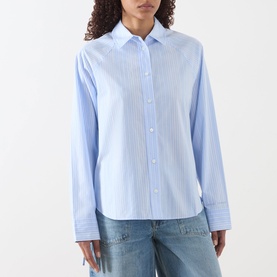 Model wearing Sams&oslash;e Sams&oslash;e Sarita Striped Shirt in Windsurfer St, light blue stripe, point collar, buttoned cuffs, styled with blue jeans.