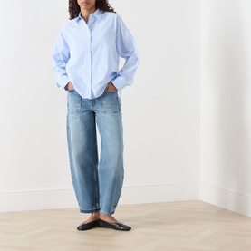 Model wearing Samsoe & Samsoe Sarita Striped Shirt in Windsurfer St with light-wash barrel-leg jeans and black ballet flats