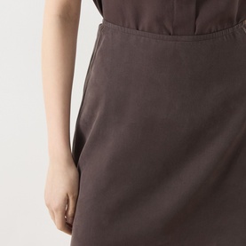 Model wearing Samsoe & Samsoe Saagnet Mini Skirt in Mulch, showing side zip fastening detail on fluid TENCEL fabric.