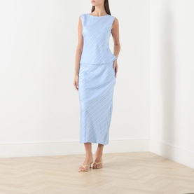 Model wearing Samsoe & Samsoe windsurfer blue textured midi skirt, styled with matching sleeveless top and strappy heeled sandals.